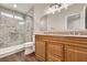 Updated bathroom features a double vanity, granite countertops and tiled walk-in shower at 3709 Ferrell St, North Las Vegas, NV 89032