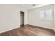 An ample bedroom features wood-look floors and bright, shuttered windows at 3709 Ferrell St, North Las Vegas, NV 89032