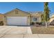 Single-story home with a two-car garage, easy-care landscape and neutral stucco at 3709 Ferrell St, North Las Vegas, NV 89032