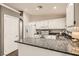Bright kitchen features white cabinets, granite countertops and stainless steel appliances at 3709 Ferrell St, North Las Vegas, NV 89032