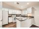 Well lit kitchen features white cabinets, granite countertops and stainless steel appliances at 3709 Ferrell St, North Las Vegas, NV 89032