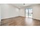 Open living room with hard wood floors and glass sliding doors to the pool at 3709 Ferrell St, North Las Vegas, NV 89032