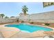 A beautiful pool features a waterfall and mature desert landscaping for privacy at 3709 Ferrell St, North Las Vegas, NV 89032