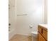 Simple bathroom featuring a shower-tub combo, toilet and a wooden vanity at 38 E Serene Ave # 134, Las Vegas, NV 89123