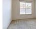 Bright bedroom featuring neutral carpeting and a large window with blinds at 38 E Serene Ave # 134, Las Vegas, NV 89123