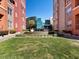 Lush courtyard with manicured lawn and glass buildings at Manhattan Condominiums at 38 E Serene Ave # 134, Las Vegas, NV 89123