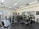 Community gym with weightlifting equipment, including free weights and machines, and mirrored walls at 38 E Serene Ave # 134, Las Vegas, NV 89123