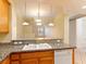 Bright kitchen featuring granite countertops, wooden cabinets, and stainless steel appliances at 38 E Serene Ave # 134, Las Vegas, NV 89123
