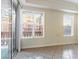 View of bright living room featuring a sliding glass door to a balcony and large windows at 38 E Serene Ave # 134, Las Vegas, NV 89123