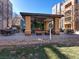 Outdoor lounge and dining area, complete with grills, comfortable seating, and lush landscaping at 38 E Serene Ave # 134, Las Vegas, NV 89123