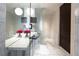 Contemporary bathroom featuring marble floors, vanity, vessel sink, and wall mounted TV at 4381 W Flamingo Rd # 2903, Las Vegas, NV 89103