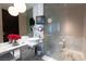 Contemporary bathroom featuring marble floors, vanity, vessel sink, and wall mounted TV at 4381 W Flamingo Rd # 2903, Las Vegas, NV 89103