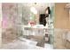 Modern bathroom featuring marble tile, glass-enclosed shower, and stylish vanity with round sink and dual pendant lighting at 4381 W Flamingo Rd # 2903, Las Vegas, NV 89103