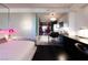 Modern bedroom featuring a king size bed, glass desk, and kitchenette in the background at 4381 W Flamingo Rd # 2903, Las Vegas, NV 89103