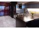 Compact kitchenette with stainless steel appliances and marble tile flooring at 4381 W Flamingo Rd # 2903, Las Vegas, NV 89103