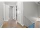 Light-filled hallway with wood-look floors and access to bedrooms at 4574 Casa Mia Cir, Las Vegas, NV 89121