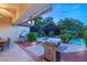 Evening view of patio with grill and pool in background at 4649 Bird View Ct, Las Vegas, NV 89129