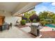 Relaxing backyard patio with built-in grill, dining area, and access to pool at 4649 Bird View Ct, Las Vegas, NV 89129