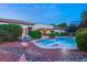 Relaxing backyard with a beautiful pool, landscaping, and patio furniture at 4649 Bird View Ct, Las Vegas, NV 89129