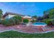 Landscaped backyard with pool and rock features at night at 4649 Bird View Ct, Las Vegas, NV 89129