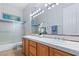 Double vanity bathroom with wood cabinets and a shower/tub combo at 4649 Bird View Ct, Las Vegas, NV 89129