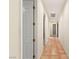 Long hallway with terracotta tile flooring and access to other rooms at 4649 Bird View Ct, Las Vegas, NV 89129