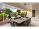 Outdoor patio with dining table, pizza oven, and pool view at 4649 Bird View Ct, Las Vegas, NV 89129