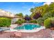 Inviting kidney-shaped pool surrounded by lush landscaping at 4649 Bird View Ct, Las Vegas, NV 89129