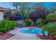 Peaceful patio with a kidney-shaped pool, surrounded by greenery at 4649 Bird View Ct, Las Vegas, NV 89129