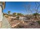 Landscaped backyard with desert plants and stone pathway at 4750 Fiore Bella Blvd, Las Vegas, NV 89135