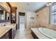 Spa-like bathroom with soaking tub, walk-in shower, and marble finishes at 4750 Fiore Bella Blvd, Las Vegas, NV 89135