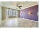 Large bedroom with ceiling fan, bay window, and purple accent wall at 4750 Fiore Bella Blvd, Las Vegas, NV 89135