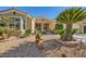 Tan house with palm trees and desert landscaping in front at 4750 Fiore Bella Blvd, Las Vegas, NV 89135