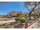 Single story house with desert landscaping, and mature trees along the sidewalk at 4750 Fiore Bella Blvd, Las Vegas, NV 89135