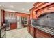 Gourmet kitchen features dark wood cabinets, granite counters, and stainless steel appliances at 4750 Fiore Bella Blvd, Las Vegas, NV 89135
