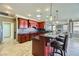 Spacious kitchen with dark wood cabinets, granite countertops, and stainless steel appliances at 4750 Fiore Bella Blvd, Las Vegas, NV 89135