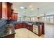 Kitchen with granite countertops, dark wood cabinets, and stainless steel appliances at 4750 Fiore Bella Blvd, Las Vegas, NV 89135