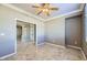 Open living space with kitchen views, tile floors, and a ceiling fan at 4750 Fiore Bella Blvd, Las Vegas, NV 89135