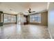 Spacious living room with tile floors, a ceiling fan, and access to a patio at 4750 Fiore Bella Blvd, Las Vegas, NV 89135