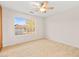 Bright bedroom with large window, ceiling fan and wood-look tile floors at 5009 Elm Grove Dr, Las Vegas, NV 89130