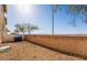Small backyard with gravel, block wall, and distant mountain views at 5555 Sun Temple Ave, Las Vegas, NV 89139