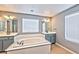 Bathroom with double sinks, a bathtub, and gray cabinets at 5555 Sun Temple Ave, Las Vegas, NV 89139