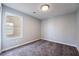 Well-lit bedroom with carpet flooring and a window offering natural light at 5555 Sun Temple Ave, Las Vegas, NV 89139