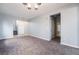 Spacious living room with neutral carpeting and a view into the hallway at 5555 Sun Temple Ave, Las Vegas, NV 89139