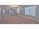 Living room with neutral paint, carpet, and natural light from large windows at 5555 Sun Temple Ave, Las Vegas, NV 89139