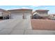 Single-story house with three-car garage and desert landscaping at 5831 Flight Wing St, Las Vegas, NV 89113