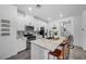 Modern kitchen with white cabinets, granite island, and patterned backsplash at 6318 Amber Sunrise St, North Las Vegas, NV 89031