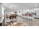 Open-concept living space with modern decor, tile floors, and a breakfast bar with seating at 6318 Amber Sunrise St, North Las Vegas, NV 89031