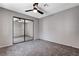 Bedroom with mirrored closet doors and ceiling fan at 6657 W Tropicana Ave # 201, Las Vegas, NV 89103