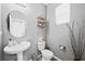 Modern bathroom with pedestal sink and circular mirror at 6955 Sunrise Crest Dr, Las Vegas, NV 89142